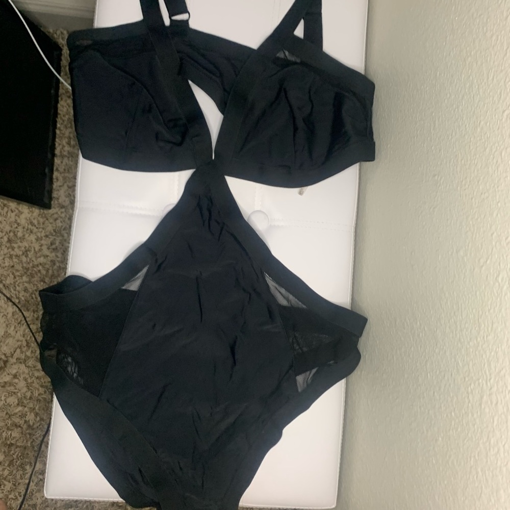 Black one piece with cutouts and mesh detail
